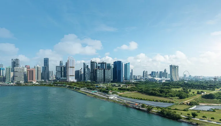 W Residences Marina View, artist’s impression: a daytime aerial across the water of Marina Bay towards the city skyline with the tower among the office towers
