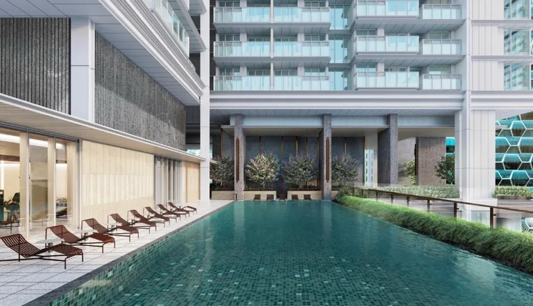 W Residences Marina View, artist&rsquo;s impression: the 25-metre lap pool on the Level 15 Wet Deck, with loungers along the edge and the residential floors rising above