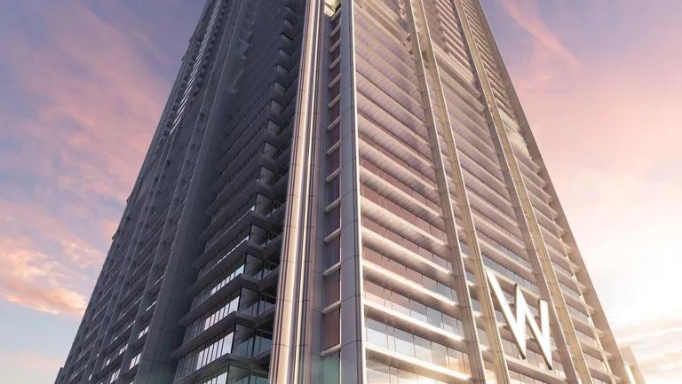 W Residences Marina View, artist&rsquo;s impression: looking up the tower at dusk to its stepped crown of vertical fins, with the W sign lit on the facade
